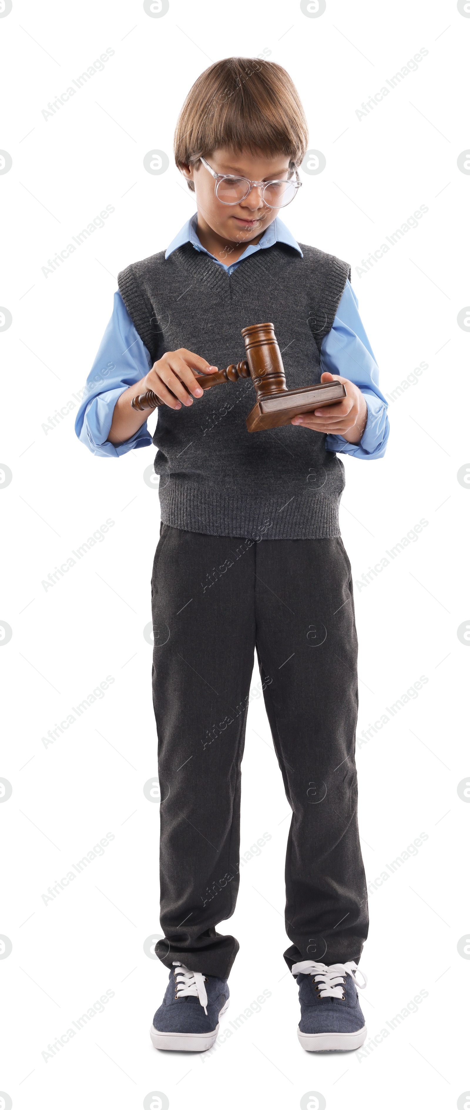 Photo of Choice of profession. Little boy in glasses with judge's gavel and sound block pretending to be lawyer on white background