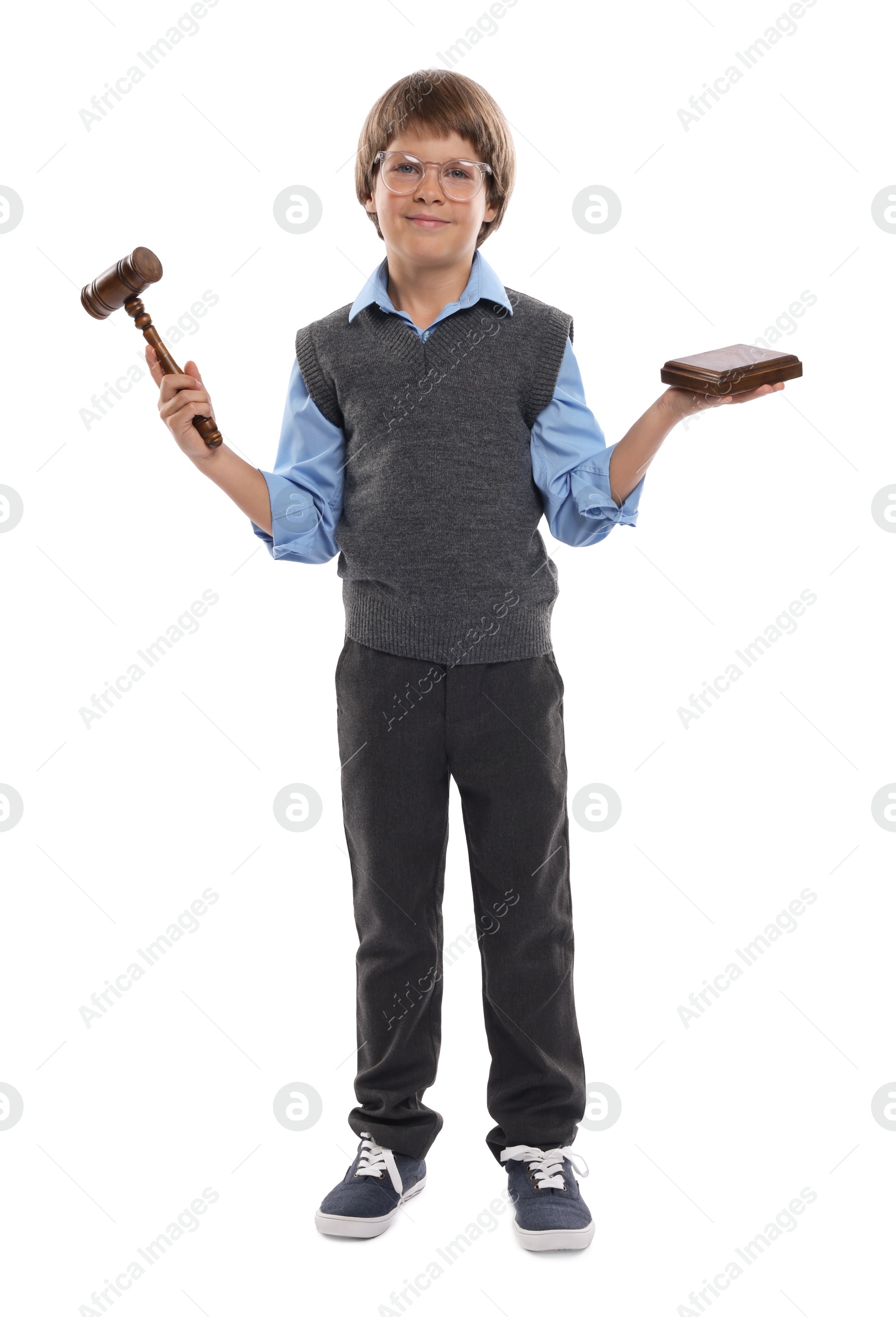 Photo of Choice of profession. Little boy in glasses with judge's gavel and sound block pretending to be lawyer on white background