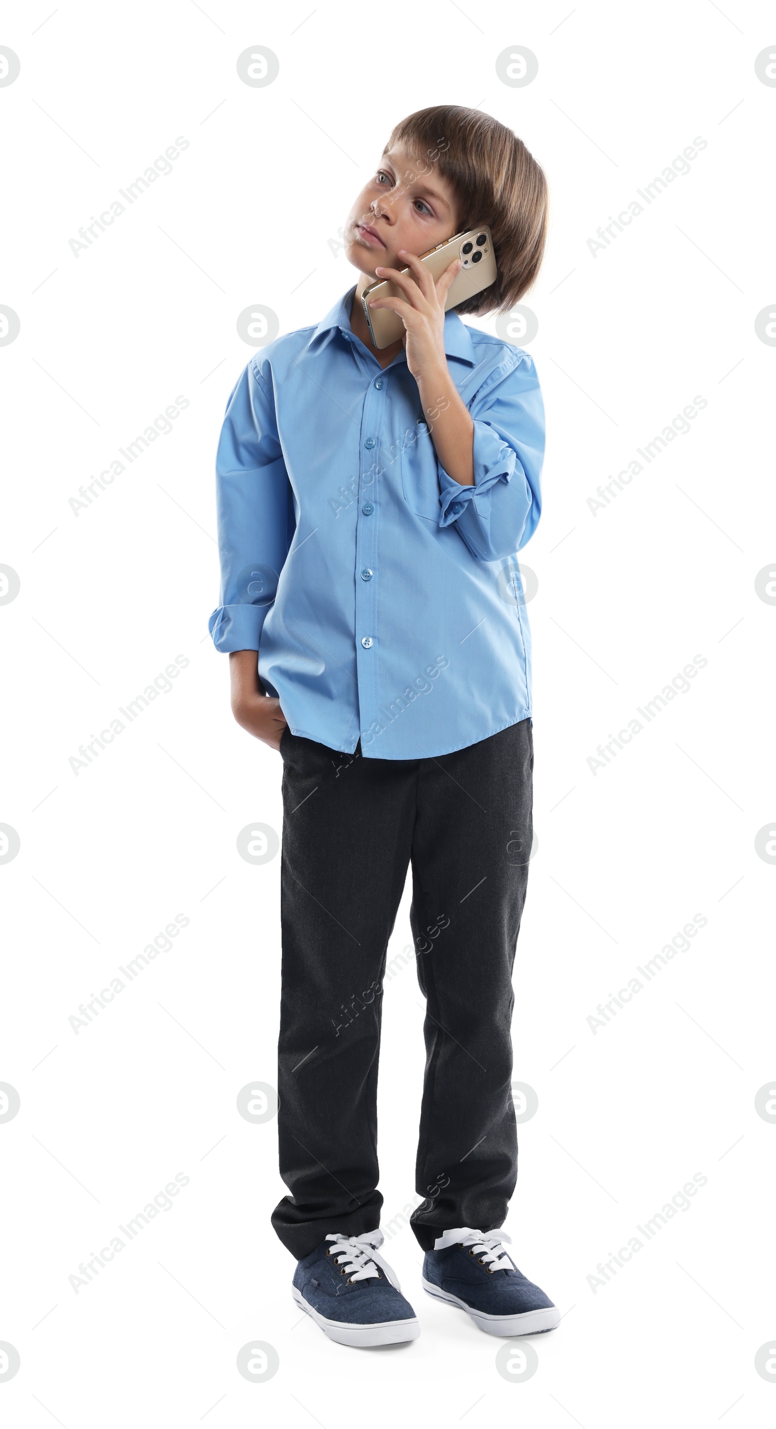 Photo of Choice of profession. Little boy talking by smartphone pretending to be businessman on white background