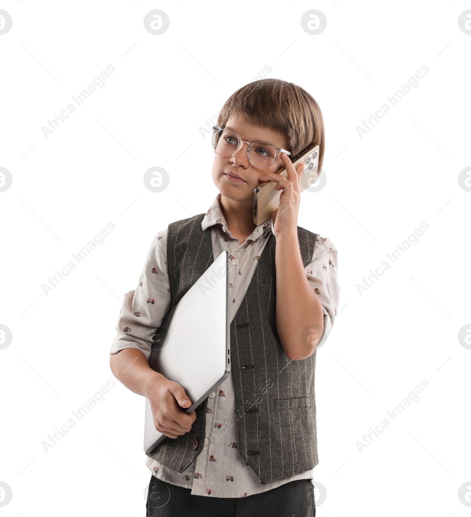 Photo of Choice of profession. Little boy in glasses talking by smartphone pretending to work with laptop on white background