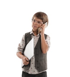 Photo of Choice of profession. Little boy in glasses talking by smartphone pretending to work with laptop on white background