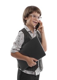 Photo of Choice of profession. Happy little boy in glasses talking by smartphone pretending to work with laptop on white background