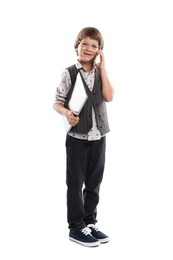 Photo of Choice of profession. Happy little boy in glasses talking by smartphone pretending to work with laptop on white background