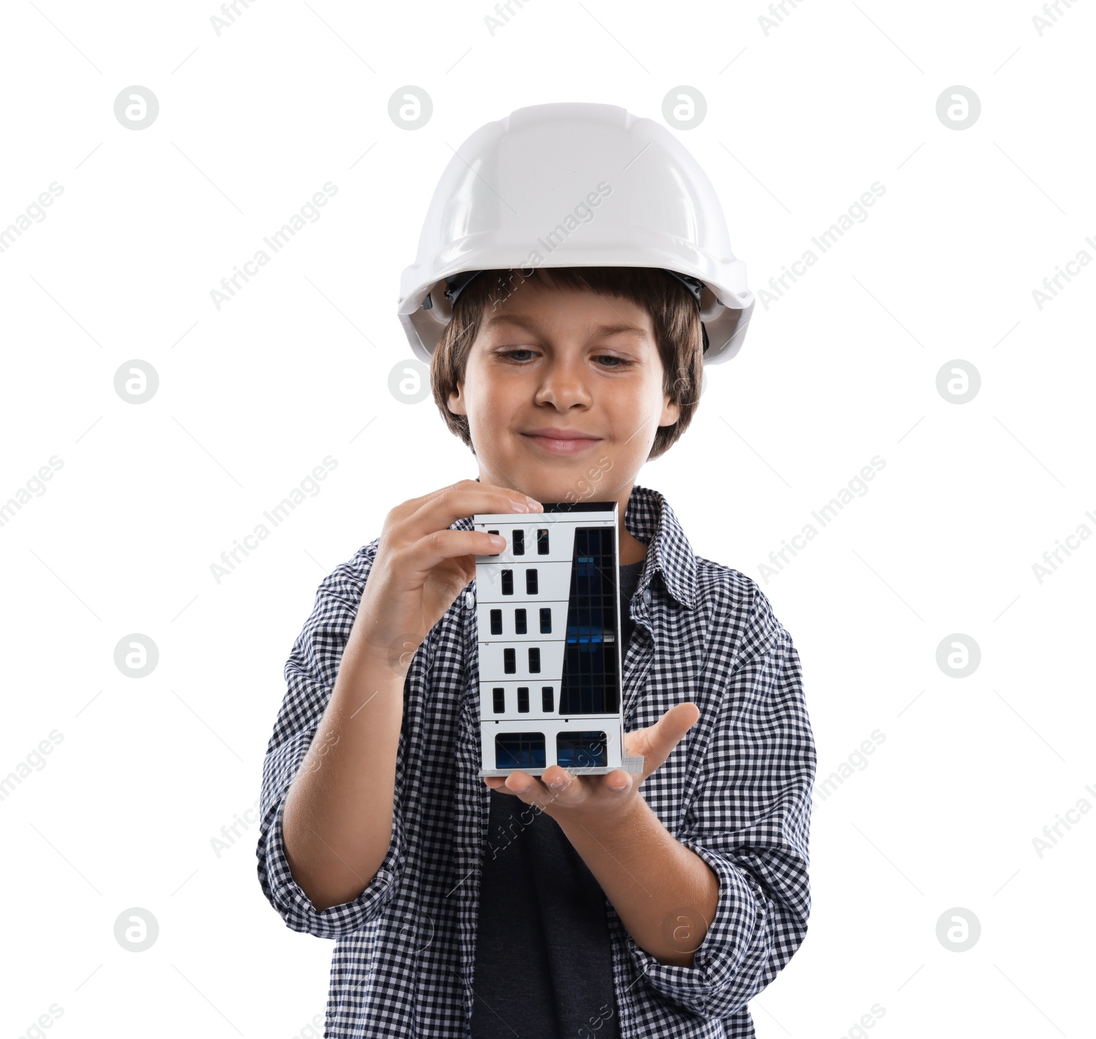 Photo of Choice of profession. Little boy in hardhat with building model pretending to be architect on white background