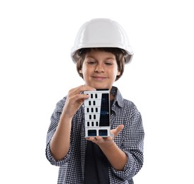 Photo of Choice of profession. Little boy in hardhat with building model pretending to be architect on white background