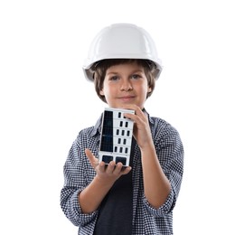 Photo of Choice of profession. Little boy in hardhat with building model pretending to be architect on white background