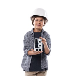 Photo of Choice of profession. Little boy in hardhat with building model pretending to be architect on white background