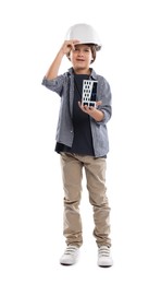 Photo of Choice of profession. Little boy in hardhat with building model pretending to be architect on white background