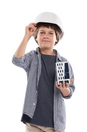 Photo of Choice of profession. Little boy in hardhat with building model pretending to be architect on white background