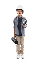 Photo of Choice of profession. Happy little boy in hardhat with building model and drawing tube pretending to be architect on white background