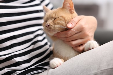 Photo of Woman with her cat at home, closeup