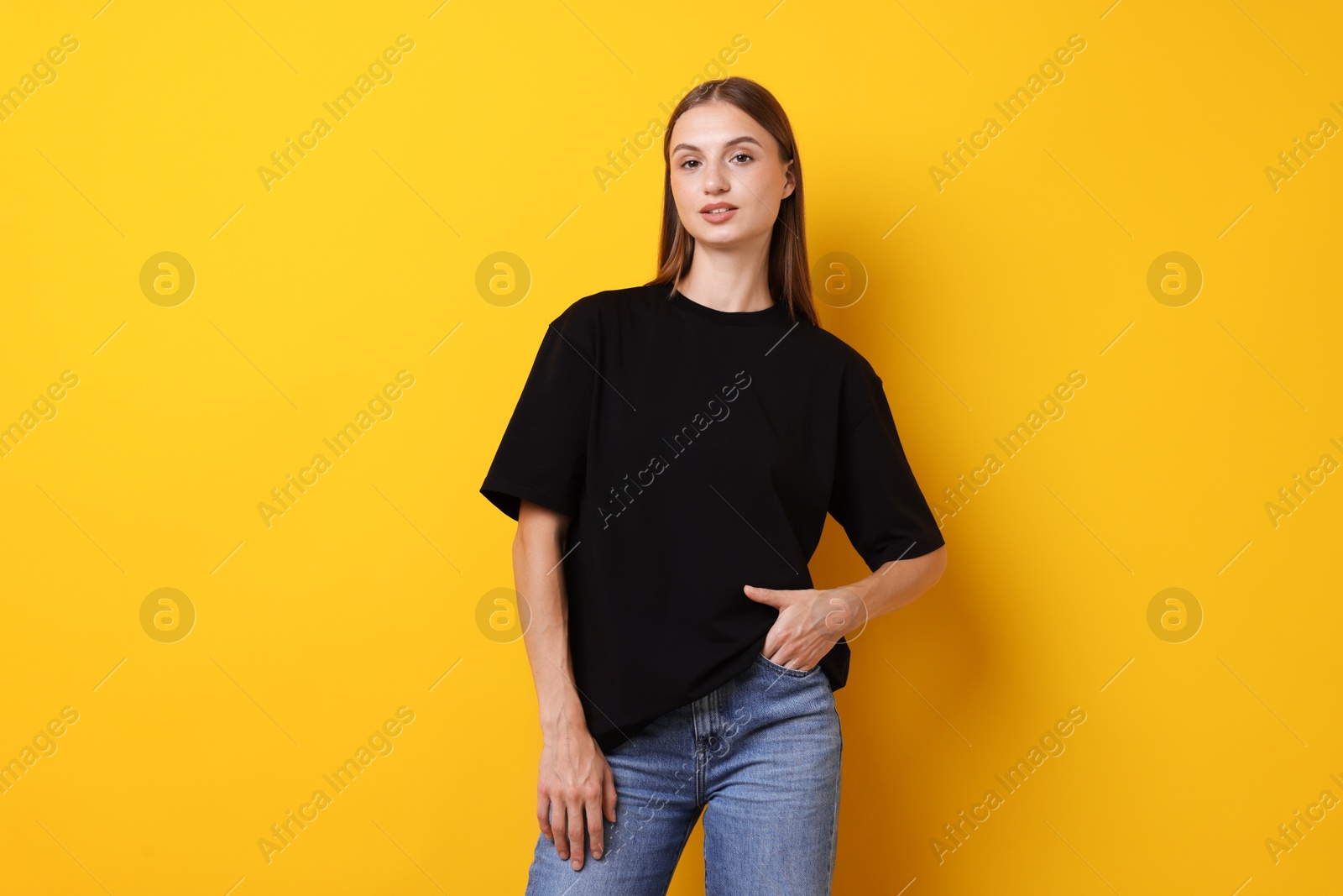 Photo of Woman wearing stylish black t-shirt on yellow background