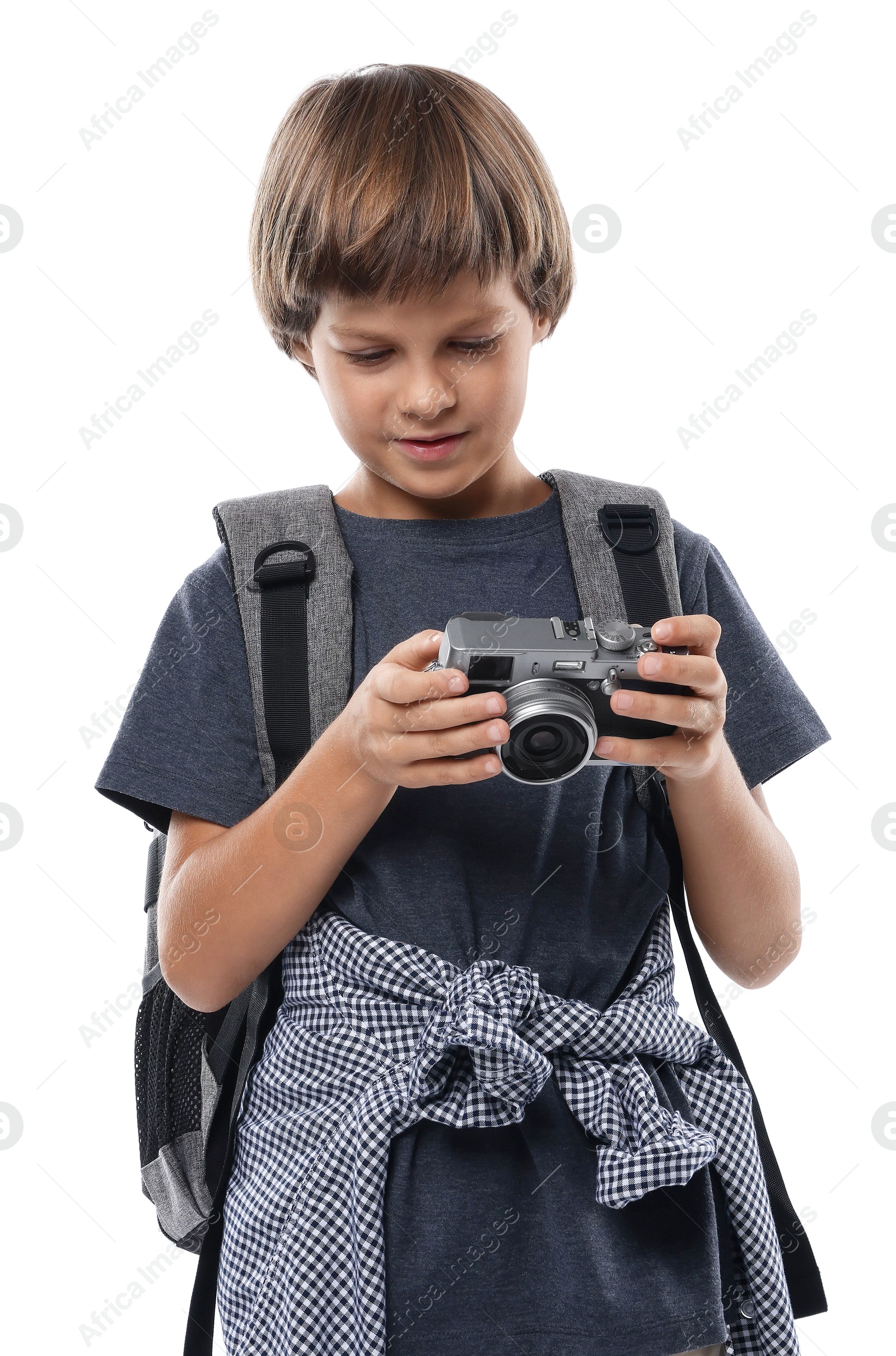 Photo of Choice of profession. Little boy with camera and backpack pretending to be photographer on white background