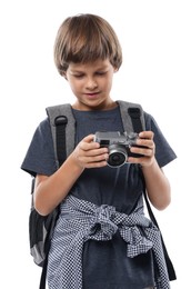 Photo of Choice of profession. Little boy with camera and backpack pretending to be photographer on white background
