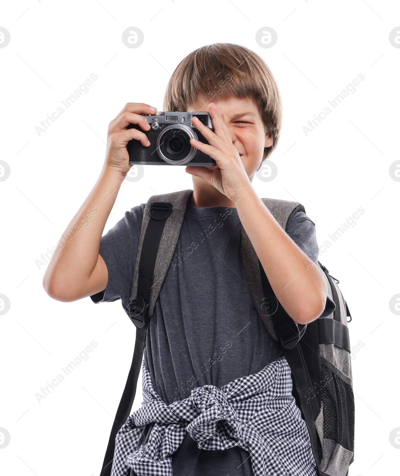 Photo of Choice of profession. Little boy with camera and backpack pretending to be photographer on white background