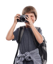 Photo of Choice of profession. Little boy with camera and backpack pretending to be photographer on white background