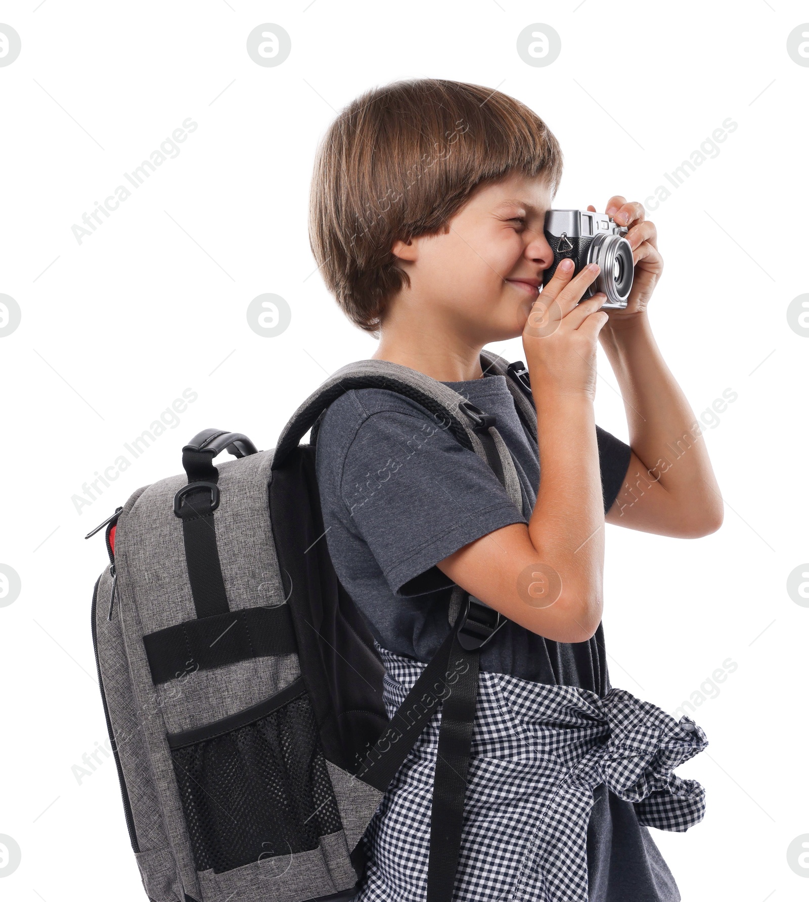 Photo of Choice of profession. Little boy with camera and backpack pretending to be photographer on white background