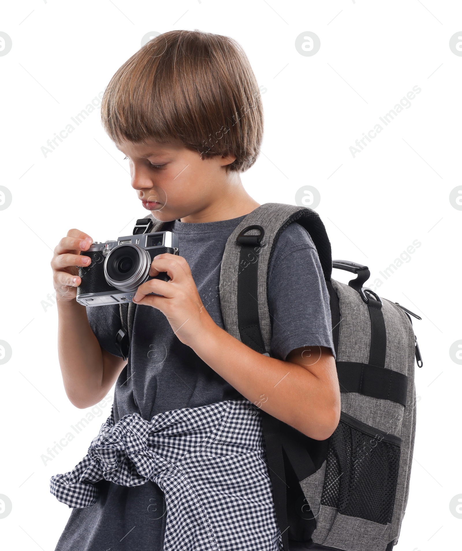 Photo of Choice of profession. Little boy with camera and backpack pretending to be photographer on white background