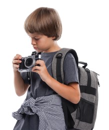 Photo of Choice of profession. Little boy with camera and backpack pretending to be photographer on white background