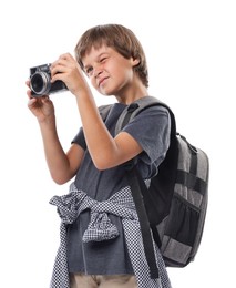Photo of Choice of profession. Little boy with camera and backpack pretending to be photographer on white background