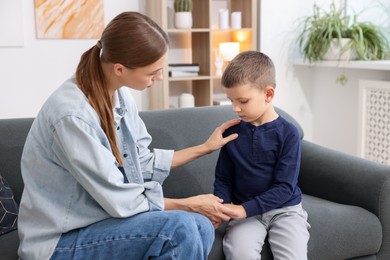 Photo of Mother supporting her upset son at home