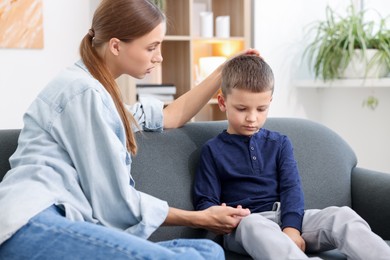 Photo of Mother supporting her upset son at home