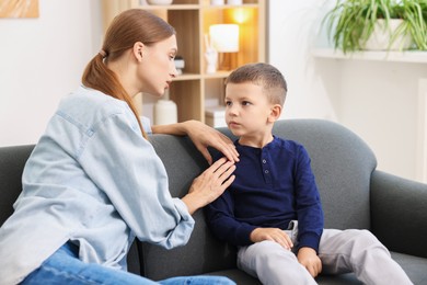 Photo of Mother supporting her upset son at home