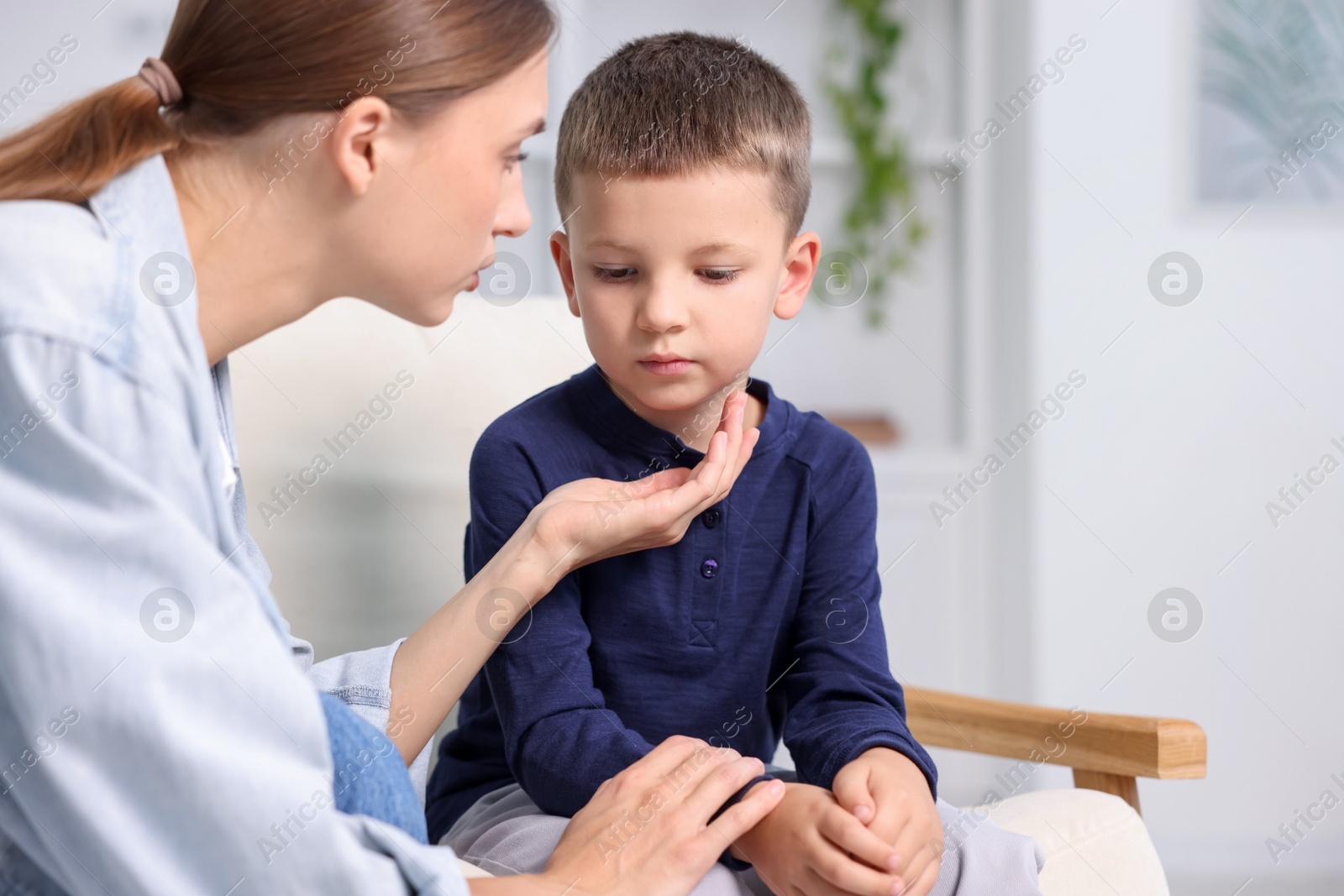 Photo of Mother supporting her upset son at home