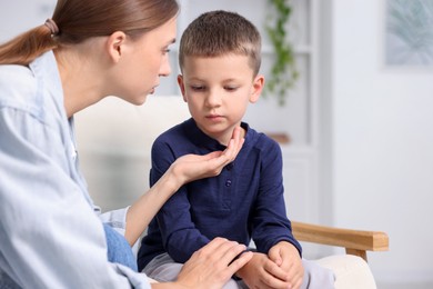Photo of Mother supporting her upset son at home