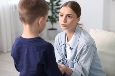 Photo of Mother supporting her upset son at home