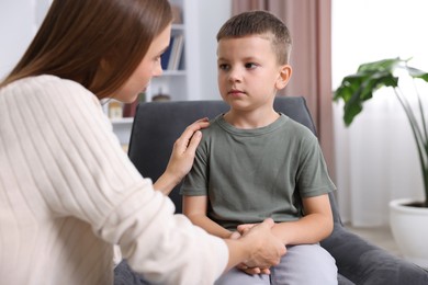 Photo of Mother supporting her upset son at home