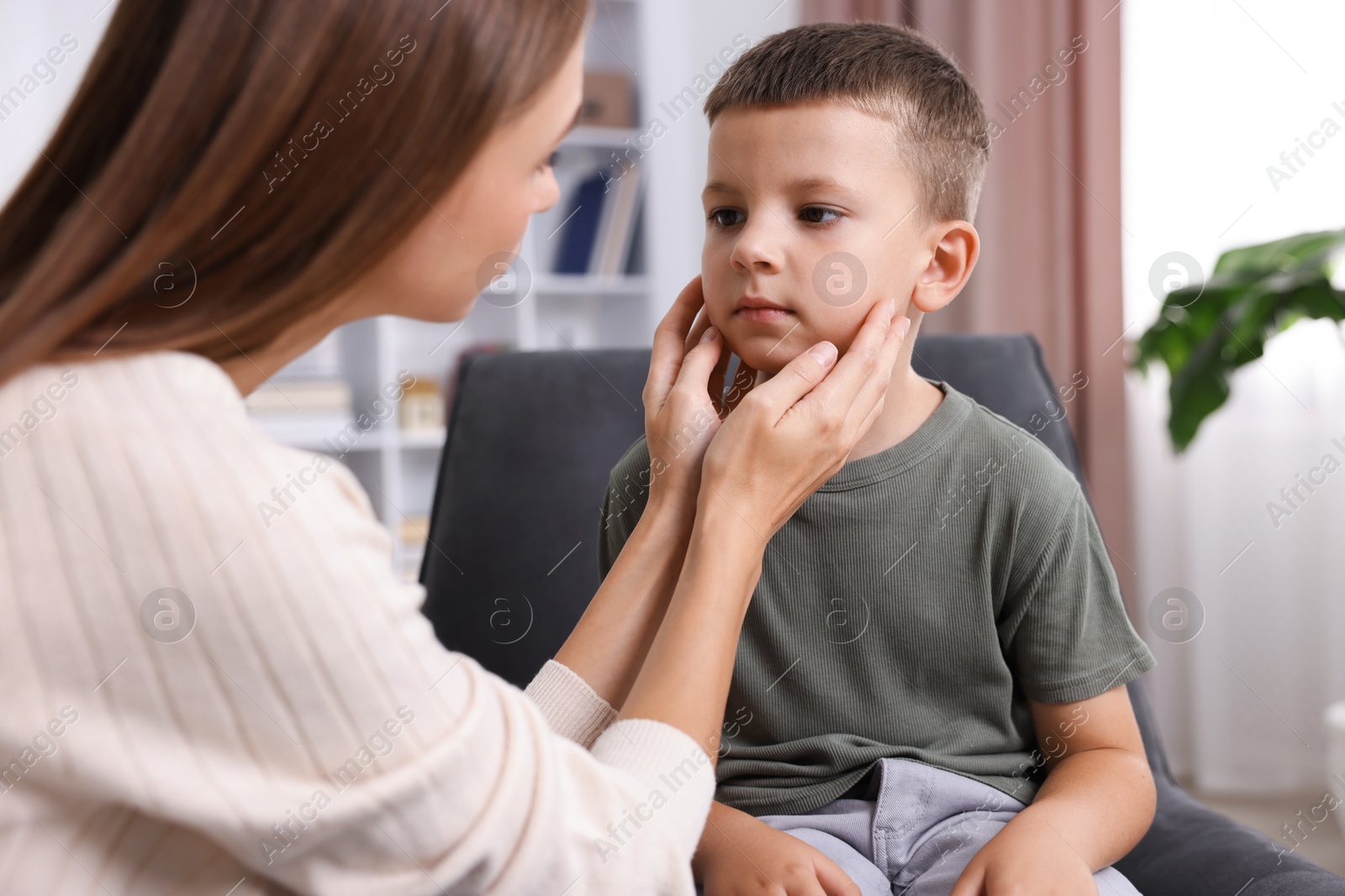 Photo of Mother supporting her upset son at home, closeup
