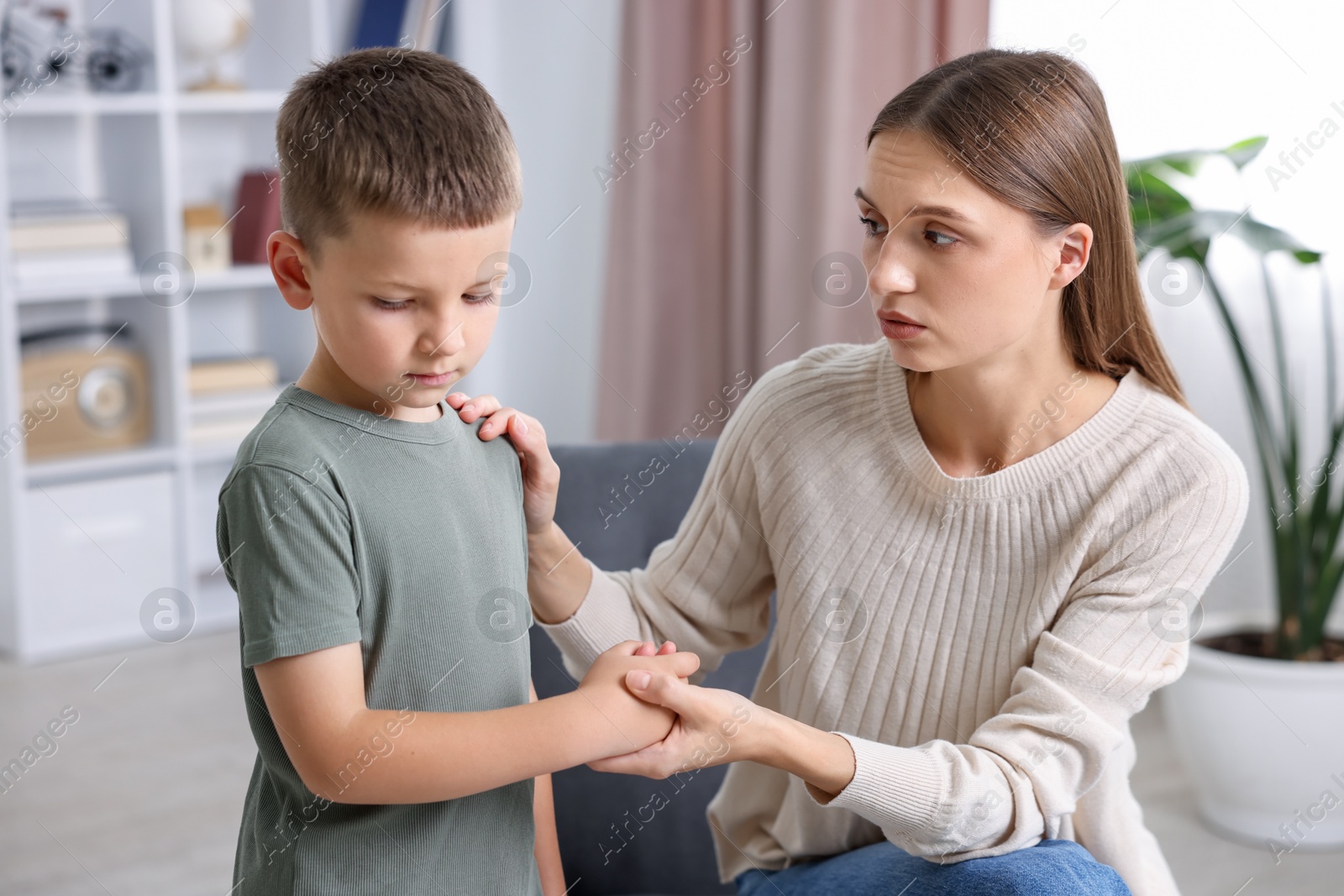 Photo of Mother supporting her upset son at home