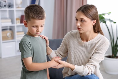 Photo of Mother supporting her upset son at home