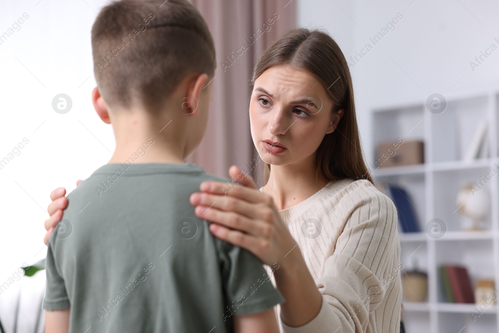 Photo of Mother supporting her upset son at home