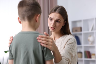 Photo of Mother supporting her upset son at home