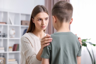 Photo of Mother supporting her upset son at home