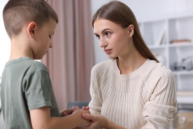 Photo of Mother supporting her upset son at home