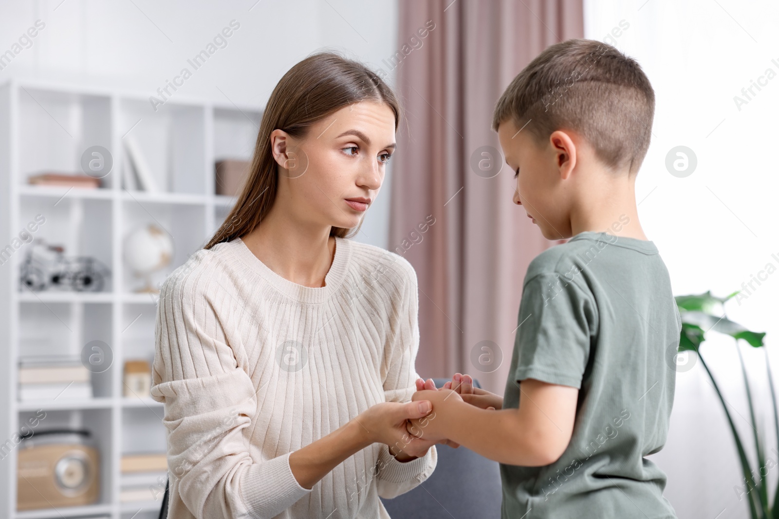Photo of Mother supporting her upset son at home