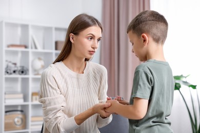 Photo of Mother supporting her upset son at home