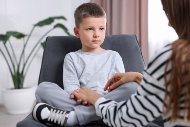 Photo of Mother supporting her upset son at home, closeup