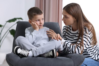 Photo of Mother supporting her upset son at home