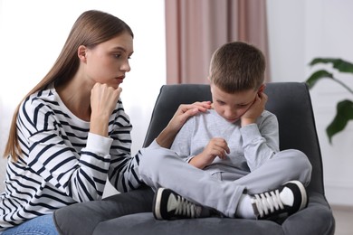 Photo of Mother supporting her upset son at home