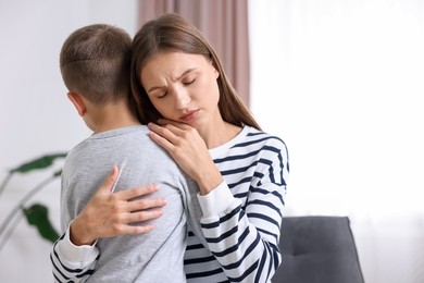 Photo of Mother supporting and hugging her upset son at home