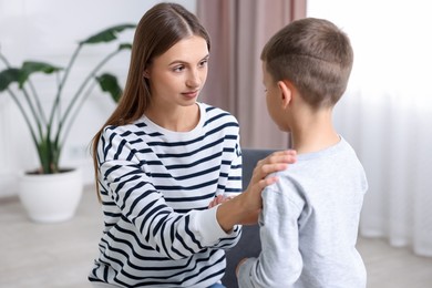 Photo of Mother supporting her upset son at home