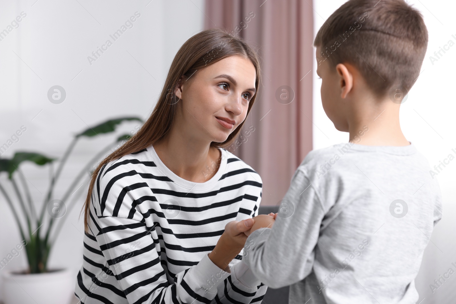 Photo of Mother supporting her upset son at home