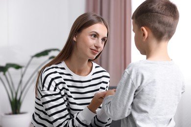 Photo of Mother supporting her upset son at home