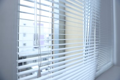 Photo of Modern window with blinds at home, closeup