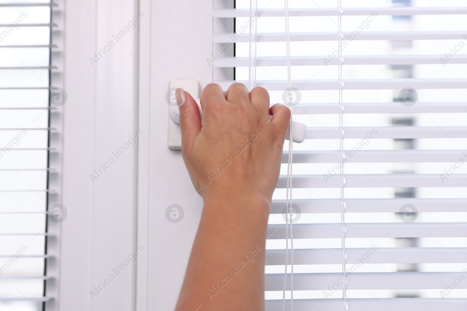 Photo of Woman opening modern window at home, closeup