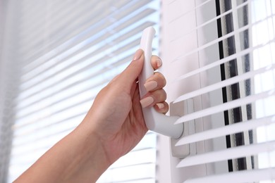 Photo of Woman opening window at home, low angle view
